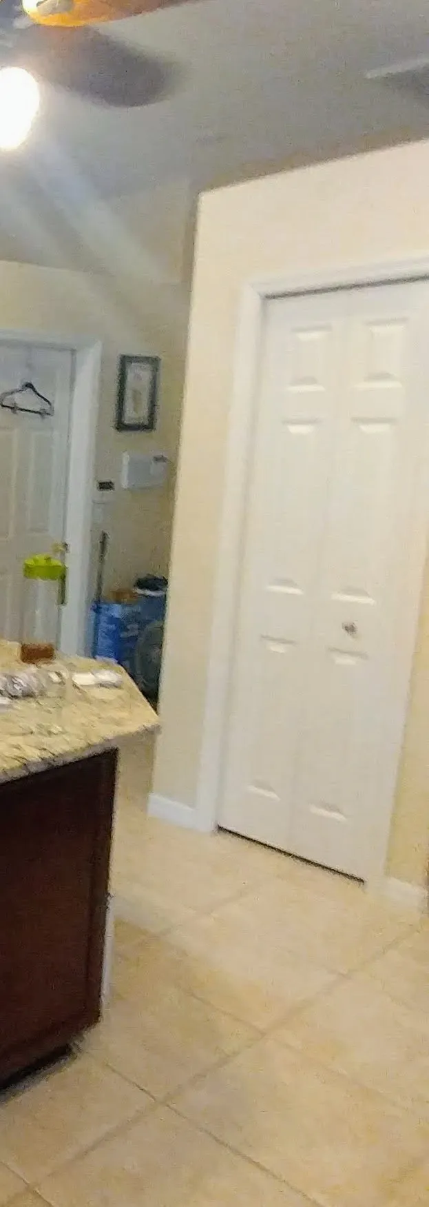 Before: Cramped white bifold pantry doors replaced with a single pre-hung door and fresh casing, opening the pantry up for more light and easier access
